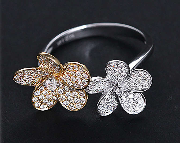 The single flower ring is yellow gold with a total of .46 ct. of diamonds. The weight is 3.6 grams. The double flower ring totals .52 ct. of diamonds and has one white gold and one yellow gold flower., The double ring has a white gold band and