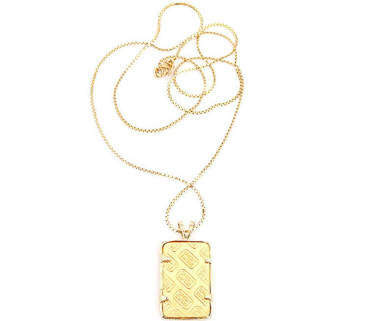 This amazing piece features a one quarter ounce Credit Suisse ingot of 999.9 pure gold in a gold bezel on a 20-inch 14k yellow gold chain necklace.