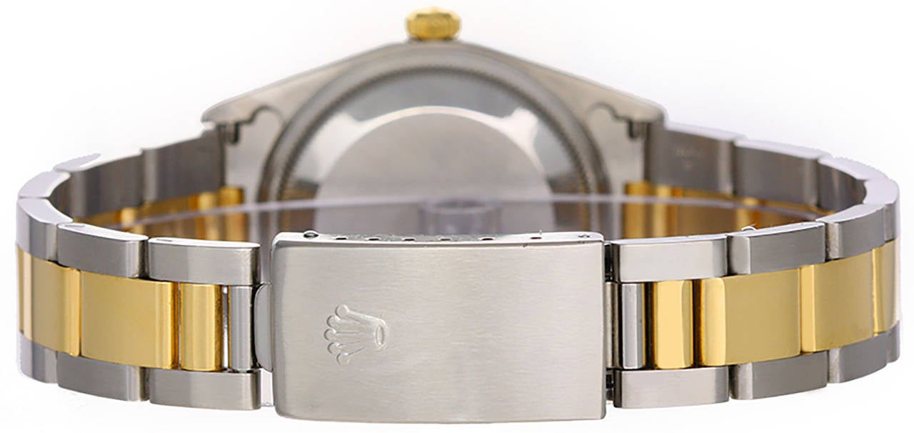 Automatic winding, 31 jewels, Quickset, sapphire crystal. Stainless steel case with 18k yellow gold fluted bezel (34mm diameter). Champagne dial with stick markers.  	Stainless steel and 18k yellow gold Oyster bracelet. Pre-owned with box.