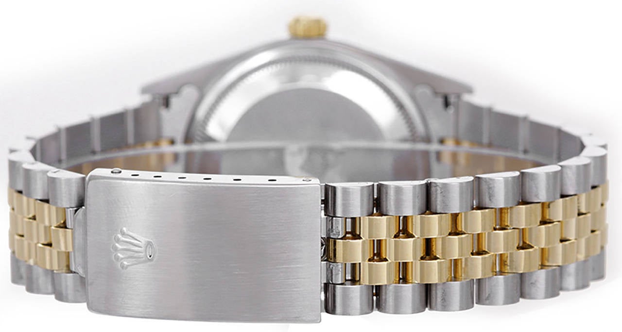 Automatic winding, 31 jewels, Quickset, sapphire crystal.  Stainless steel case with gold engine turned bezel (34mm diameter). Champagne dial with stick markers.  	Stainless steel and 18k yellow gold Jubilee bracelet. Pre-owned with box.