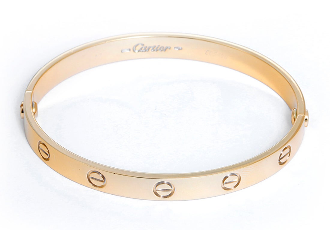 This beautiful bracelet is stamped Cartier, 17, 750  and E05496.  This is a great piece for everyday as well as dress. Authenticity guaranteed. Like new condition with no dings or scratches. Includes screwdriver.