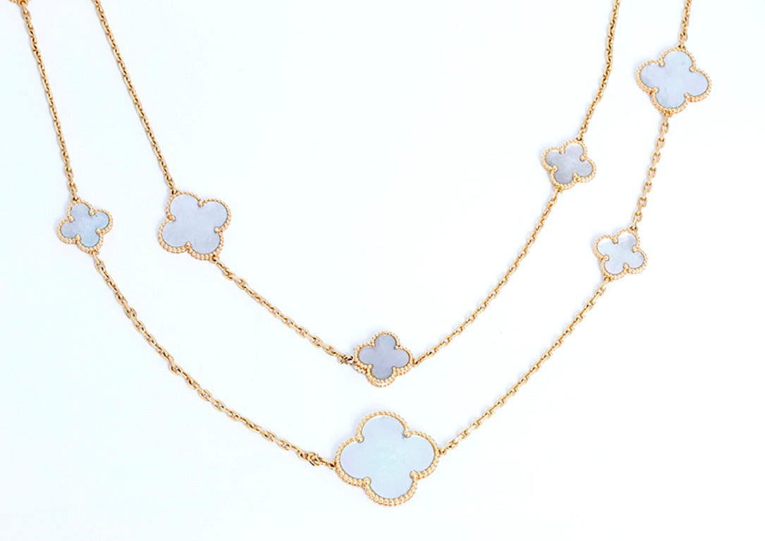 This Van Cleef & Arpels necklace is a part of the Magic Alhambra collection. The necklace features an asymmetrical design and iconic motifs in various sizes. The pendants are mother of pearl with 18k yellow gold contours. It is apx. 47-inches in