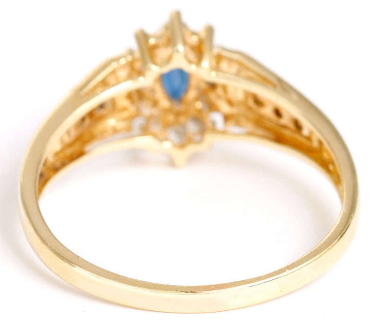 Sweet Yellow Gold and Synthetic Sapphire Ring Surrounded by Small Diamonds