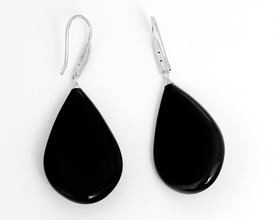 These amazing Miriam Salat earrings feature a Starburst design made up of white topaz set in sterling silver on black resin. Channel set topaz accents on bale with French hook closures. Earrings measure apx. 2-1/2 inches in length and apx. 1-inch in
