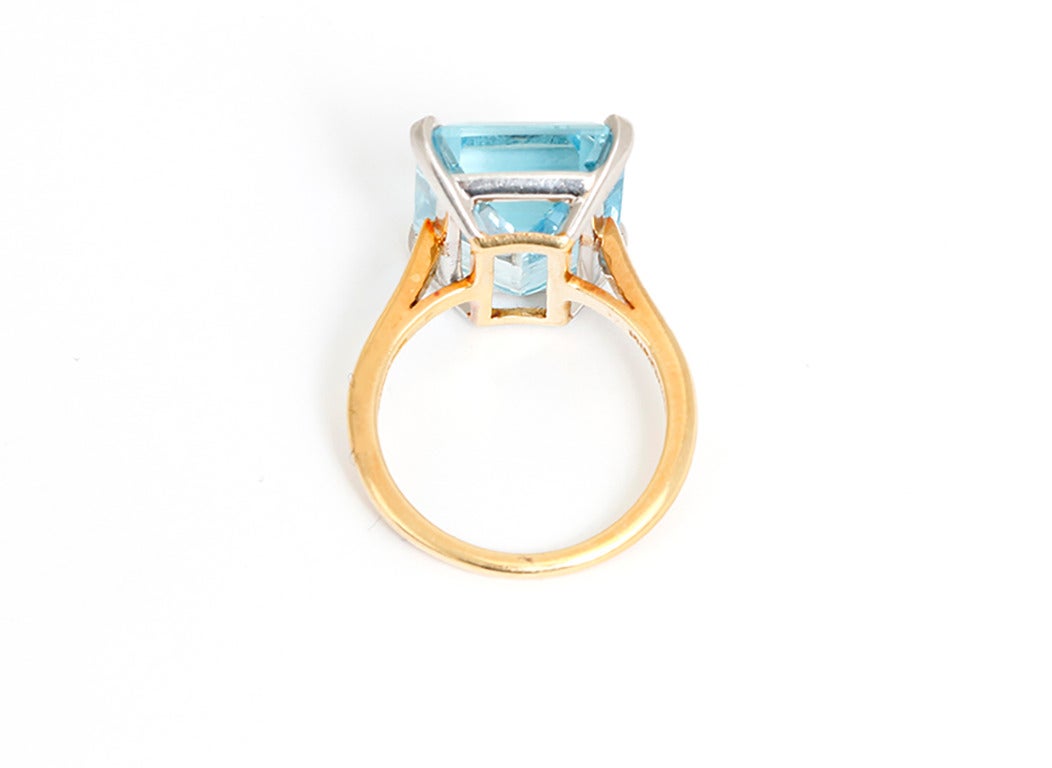 This Tiffany & Co. ring features a prong-set 8.60 carat aquamarine in platinum and 18k yellow gold. Aquamarine measures apx. 15.80 x 12.10 x 6.60 mm. Total weight is 6.6 grams. Signed. Size 6. Includes Tiffany box.