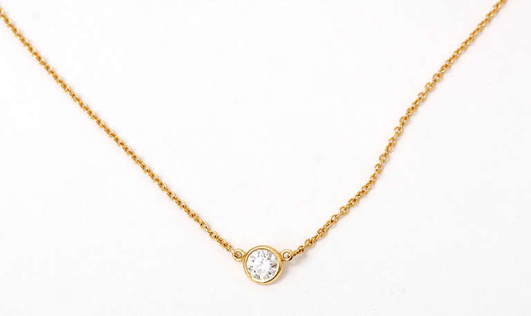 This 18k yellow gold necklace is lightweight and comfortable featuring apx. 1/3 of a carat bezel-set diamond.The necklace is apx. 17-1/2 inches in length and weighs 1.7 grams.