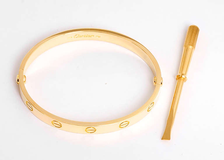 This beautiful bracelet is stamped Cartier, 16, 750  and E05410.  This is a great piece for everyday as well as dress. Authenticity guaranteed. Like new condition with no dings or scratches. Includes Cartier service receipt and screwdriver as