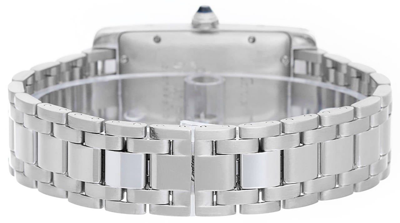 Automatic  winding. 18k white gold case (23mm x 41mm). Ivory colored dial with black Roman numerals; date at 6 o'clock position. 18k white gold Cartier bracelet. Pre-owned with box and books. Current Replacement Value: $18,900.00