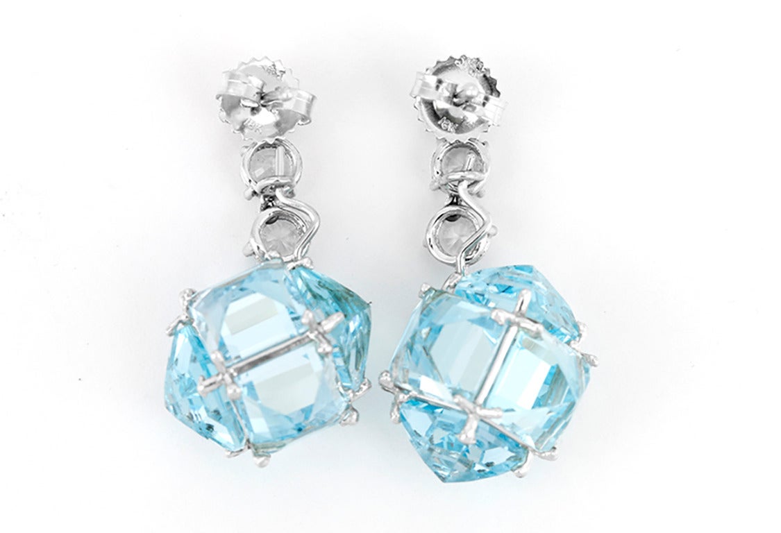From the Very PC Collection, these earrings  feature white sapphires paired with geometric pendants created from blue topaz reverse set in 18k white gold. Earrings measure apx. 1-1/4 inches in length. Total weight is 12.8 grams.