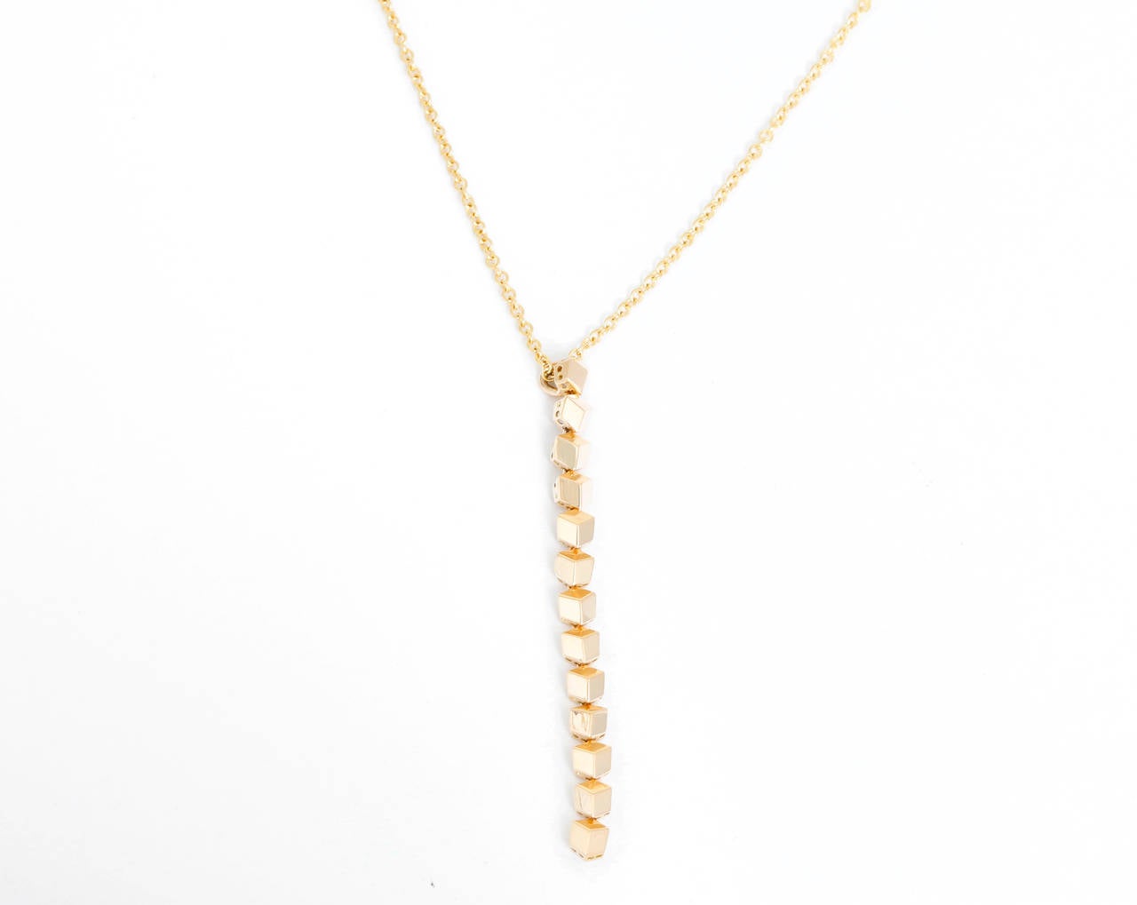 From the Brillante Collection, this necklace features an 18k yellow gold  chain and geometric style pendant. Pendant measures apx. 2-inches in length and chain measures apx. 16-inches in length. This necklace is perfect for everyday wear and special