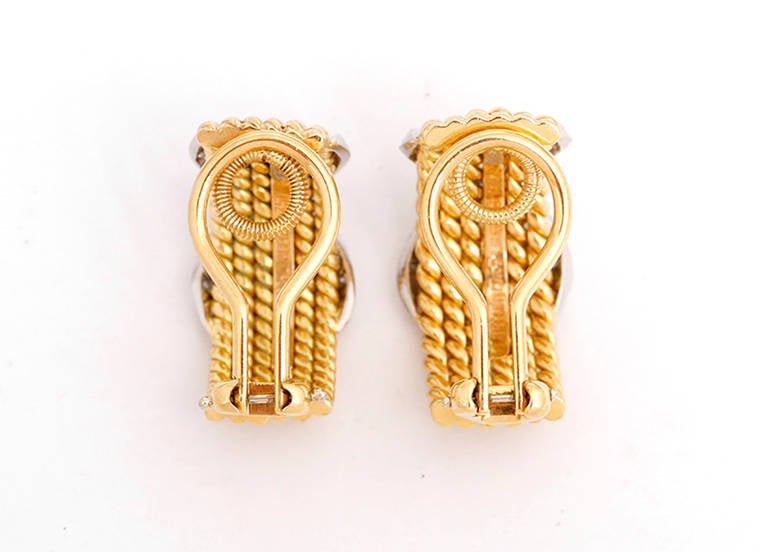 These are stunning earrings made up of 18k yellow gold twisted wire forming a rope design. The earrings feature an X with .51 ctw round brilliant pave diamonds in a platinum setting.  Each earring measures apx. 3/8-inch in width and 7/8-inch in
