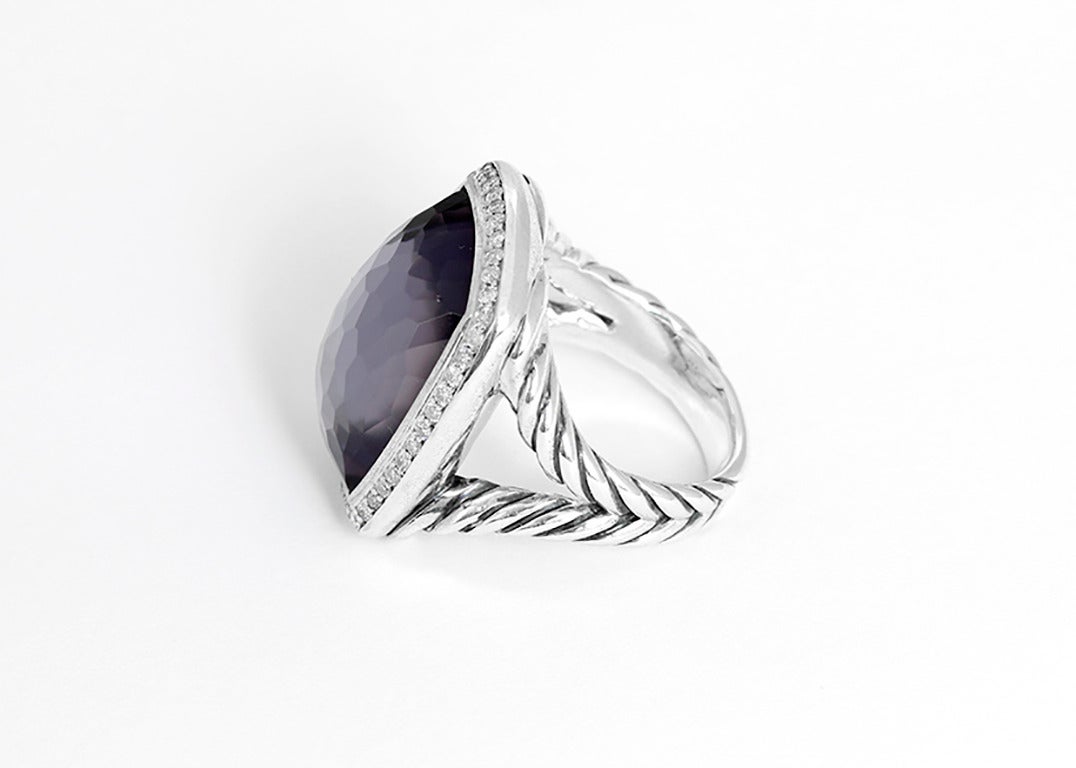 This David Yurman Albion ring has a faceted black orchid (lavender amethyst with hematine back, 20mm by 15mm) bordered by 0.39 ctw. of pave diamonds set in sterling silver. Signed DY, David Yurman, and 925. Total weight is 17.3 grams. Size 7. David