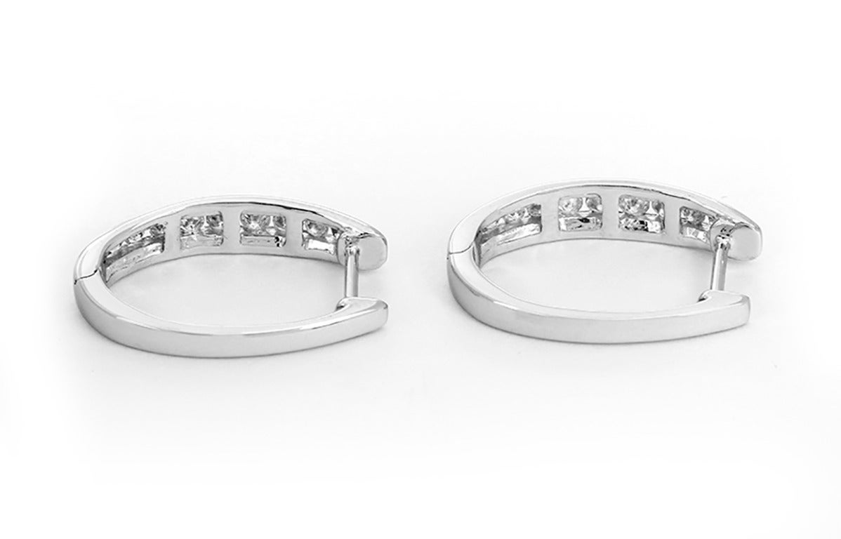 These beautiful huggie earrings feature apx. 0.50 carats of diamonds set in 14k white gold. Earrings measure apx. 3/4-inch in length with a total weight of 3.8 grams. These earrings are perfect for any outfit!