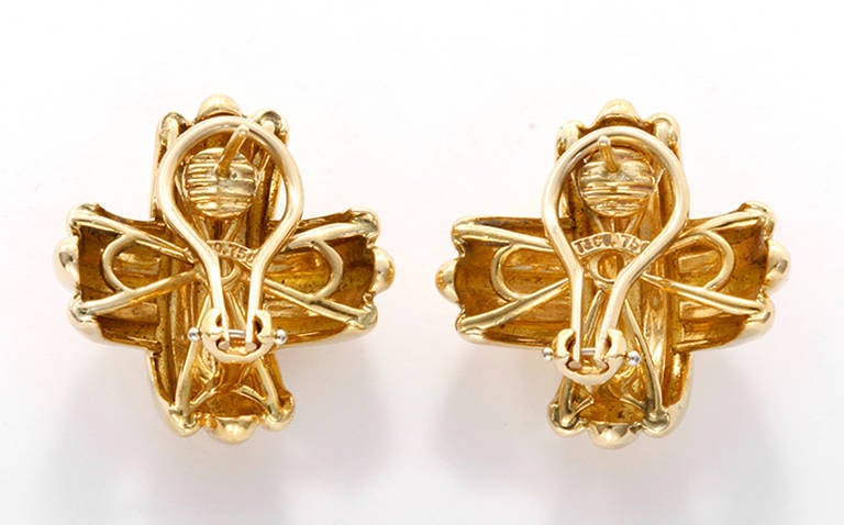 These beautiful Tiffany & Co. earrings are 18k yellow gold. They have omega style clip backs stamped T & Co., 750. They measure apx. 0.9'' in diameter and have a total weight of 21.5 grams. These earrings are perfect for any look!