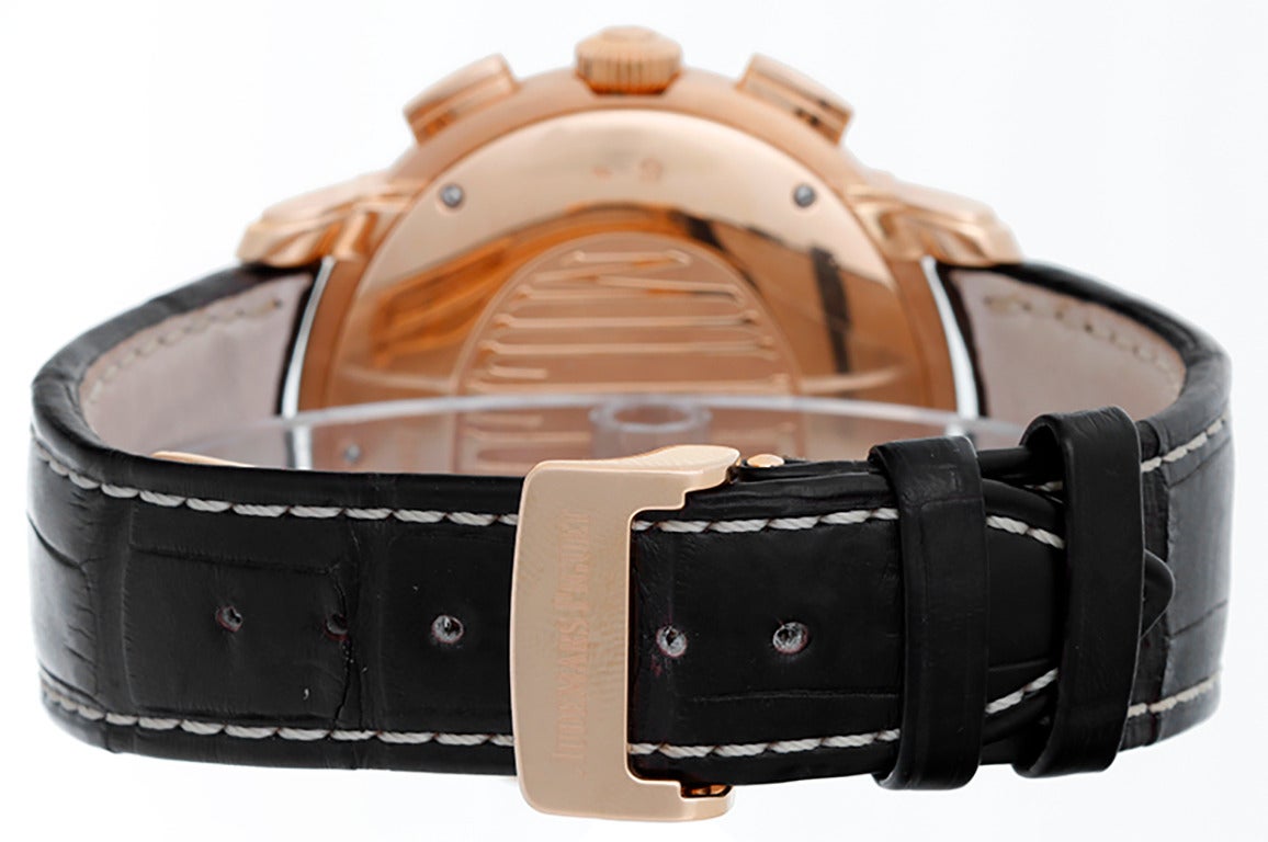 Automatic winding. 18k rose gold case (47mm x 42mm). Brown dial with gold Roman numeral hour markers and blue Arabic seconds; date between 4 & 5 o'clock; silver hour, minute & seconds subdials. Black strap band with 18k rose gold deployant clasp.