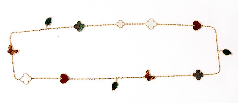 This beautiful Van Cleef & Arpels 18k yellow gold necklace is a part of the Lucky Alhambra collection. The necklace features carnelian, tiger's eye, malachite, and mother-of-pearl.  Signed VCA, Au750, JB406192. It apx. 31-inches in length with a