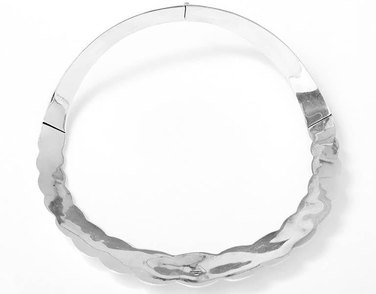 Angela Cummings designed this beautiful necklace for Tiffany & Co. It is sterling silver and measure apx. 5-inches in diameter.  It is 1-1/8 inches wide in the center front and at the narrowest it is apx. 1/2 inch wide. It weighs 91 grams. 