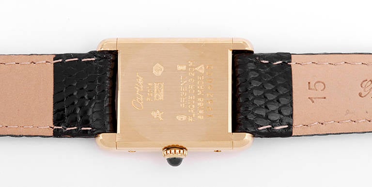 Manual winding. Gilt case, 20mm x 27mm. Black dial. Black lizard strap. Pre-owned.