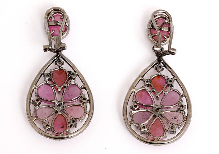 These stunning 18k earrings feature 1 carat of pink sapphire, 0.52 carat of pink tourmaline, and 0.89 carat of white and yellow diamonds. The drop measures apx. 1-1/4 inches in length and 7/8-inch at the widest. Total weight is 14.2 grams. These