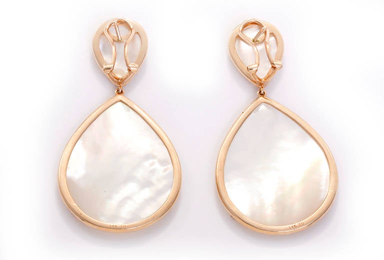 These stunning rose gold earrings feature white mother of pearl centered by a border of sparkling diamonds (1.52 CTW).  The earrings are large in size with the drop measuring apx. 1-1/2 inches in length and 1-1/8 inches at the widest. Total weight
