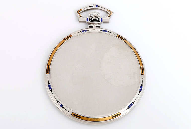 Platinum case with blue and black enamel bezel. Silvered dial with applied white gold Arabic numerals. Circa 1939.