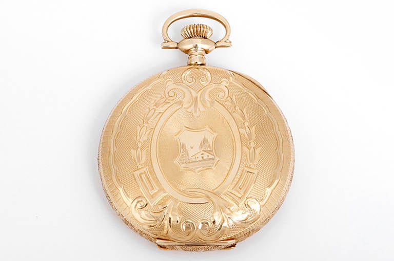 17 jewels. 14k yellow gold ornately engraved hunting case, 16 Size (49mm diameter). White enamel dial with black Roman numerals, subsidiary seconds.