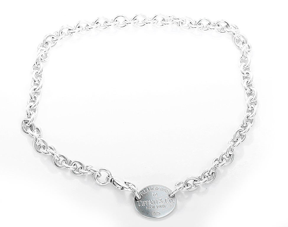 This sterling silver necklace features an engraved oval pendant stamped 