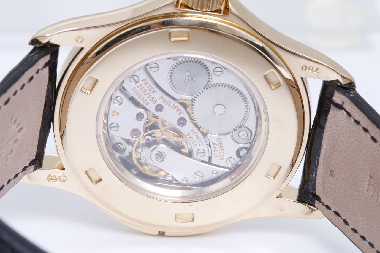 Automatic movement, dual time zone. 18k yellow gold case with exposition back, 36mm diameter. Ivory-colored dial with yellow gold Breguet numerals. Pre-owned with Patek Philippe box. With Patek Philippe strap and 18k yellow gold Patek Philippe tang