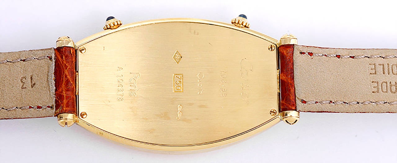 Ref. W1502853. Quartz movement. 18k yellow gold case, 26mm x 46mm. Ivory-colored dial with black Roman numerals to upper and lower time dials. Strap with gold plated Cartier buckle. Pre-owned with box and books.