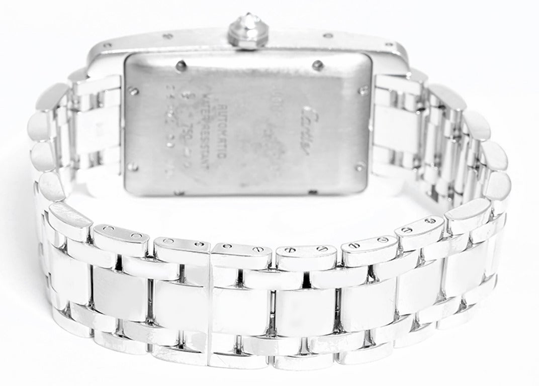 Automatic movement. 18k white gold case with factory diamond bezel, 26mm x 44mm. White dial with black Roman numerals. 18k white gold Cartier bracelet. Pre-owned with box and papers.