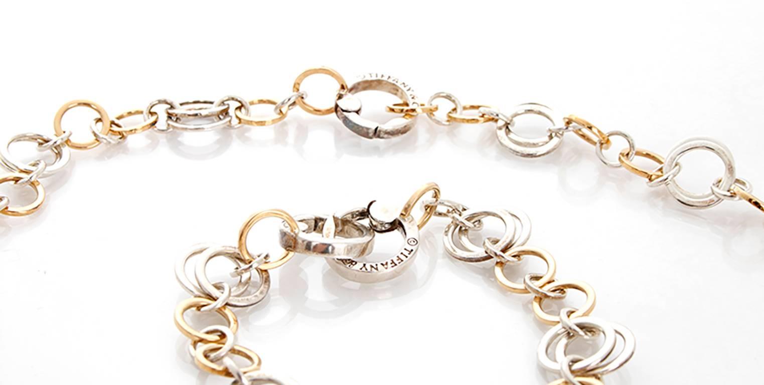 This Tiffany & Co. circle necklace and bracelet set features sterling silver and 18k yellow gold. Both stamped, 