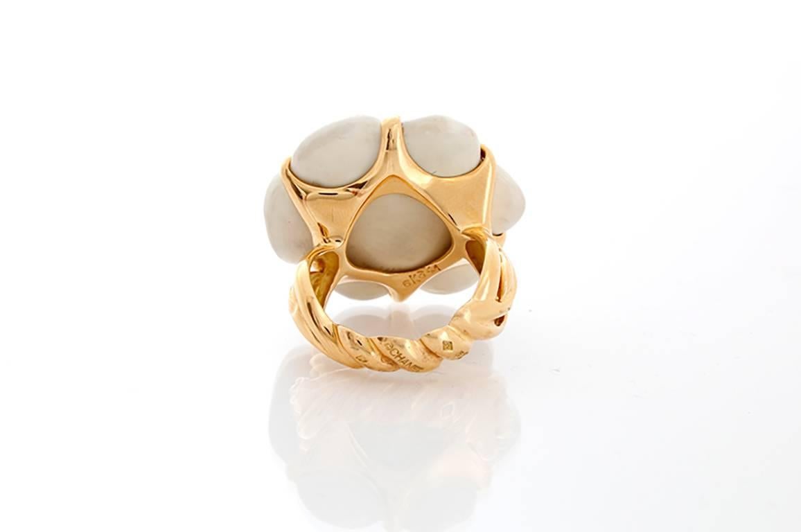 This stunning Chanel ring is a part of The Camelia Collection, featuring carved white agate (apx. 27.0 x 25.0mm) set in 18k yellow gold. Total weight is 13.6 grams. Size 5-3/4(not sizeable). Marked Chanel.