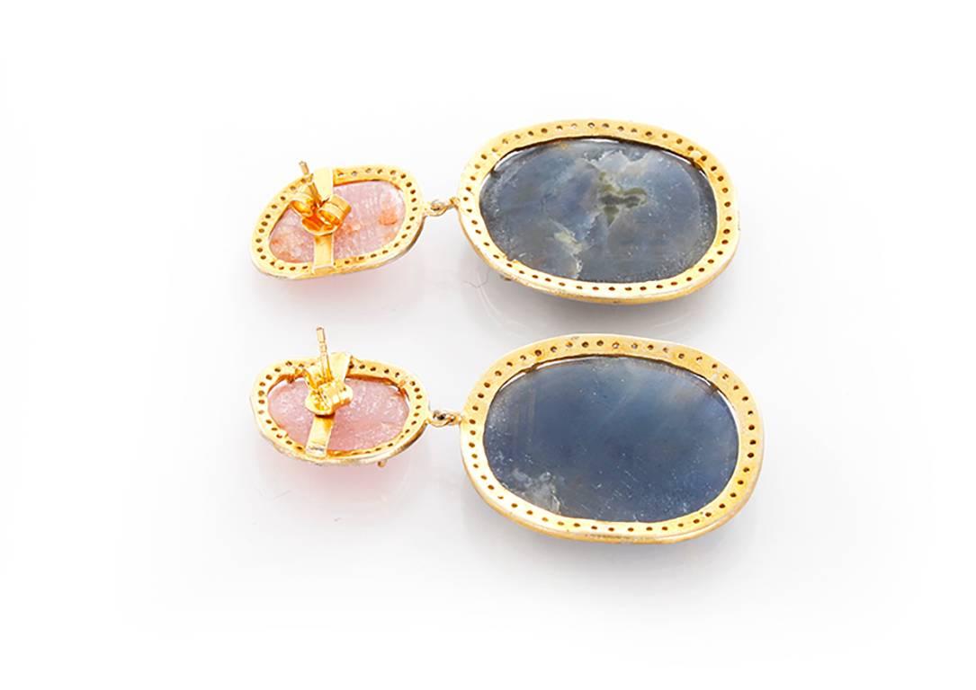 These stunning earrings feature pink and blue sapphires bordered by 1.02 carats of diamonds set in sterling silver, yellow gold plated. Earrings measure apx. 2-1/4 inches in length. Total weight is 24.1 grams.