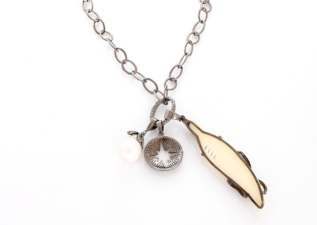 This amazing oxidized sterling silver necklace features 3 pendants -  diamond circle pendant with a star cutout design, pearl and diamond pendant, and a  diamond oxen bone  pendant with feather design; all on an oval link chain. 

Pearl and star