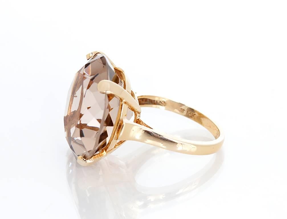This stunning ring features apx. 8-10 cts of smoky quartz set in 14k yellow gold. Smoky quartz measures apx. 16.0mm in diameter and 9.0mm in height. Total weight is 9.2 grams.  Size 6.5.