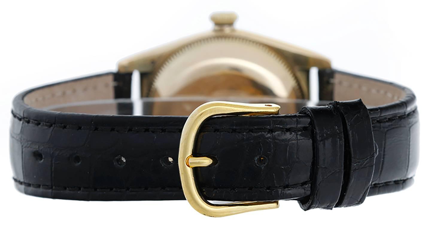 Automatic winding. 14k yellow gold case with smooth bezel (31mm diameter). Black luminous-style Roman Arabic dial. Strap band. Pre-owned with custom box; Vintage ca. 1940's.