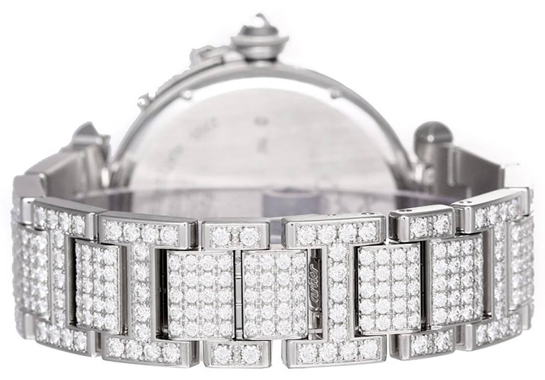 Automatic winding. 18k white gold case with factory diamond bezel (42mm diameter). Silvered guilloche dial with black Roman numerals. 18k white gold Cartier factory fully paved diamond bracelet with deployant clasp.  	Pre-owned with Cartier box and