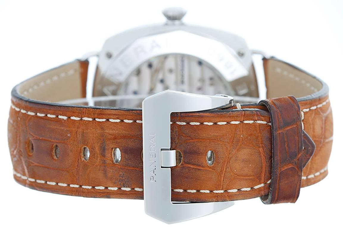 Manual winding with 8-day power reserve. Stainless steel case with exposition back (44mm diameter). Black dial with luminous-style stick markers and Arabic numerals; subseconds at 9 o'clock position. Panerai strap band and stainless steel buckle.
