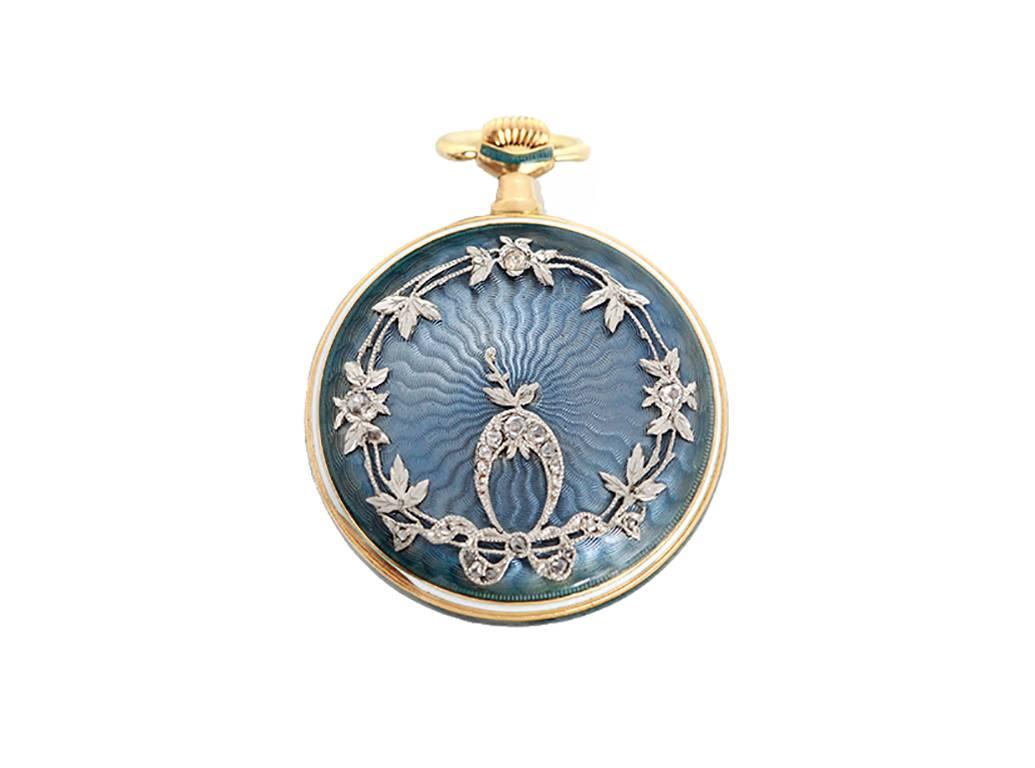  Manual winding. 18k gold and enamel case  (28mm diameter). Case back is engine turned blue enamel  with raised white gold and diamonds in a vine design. Gold engine turned sunray dial with black Roman numerals. Made my well known, high-end,