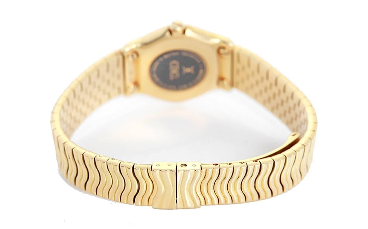 Quartz. 18k yellow gold case (24mm diameter). Ivory colored dial with gold Roman numeral. 18k yellow gold Sportwave bracelet (will fit apx. 6-in. wrist). Pre-owned with custom box.