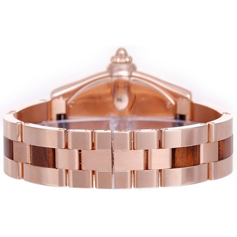 Cartier 18k rose gold extra large men's Roadster wristwatch with burlwood dial and bracelet links, Ref. W6206001, with automatic movement and date. Large 18k rose gold case, 40mm x 55mm. Burlwood dial with white Roman numerals, date at 3 o'clock.