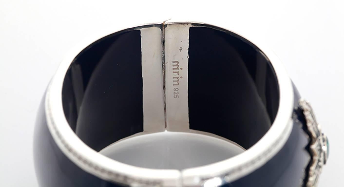 This amazing Miriam Salat navy resin and sterling silver cuff bracelet features a medallion with white and blue topaz. Cuff measures apx. 6-1/2 inches in circumference and apx. 1-1/2 inches in width with a magnetic closure. Total weight is 128.2