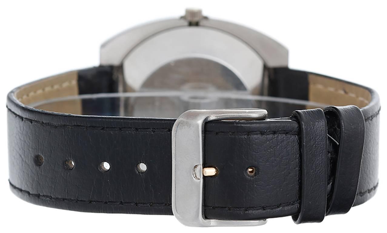 Automatic winding. Stainless steel cushion style case (39mm x 39mm). Black dial with steel and red stick markers; date at 3 o'clock. Strap band. Pre-owned with custom box.