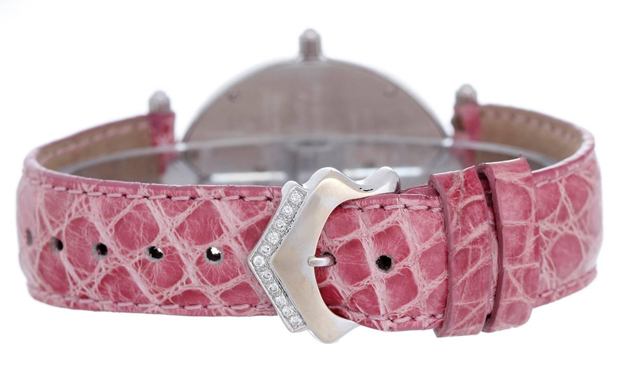 Quartz. 18k white gold case with white diamond bezel and white diamond accents (30mm x 45mm). Pink mother of Pearl dial with pave diamond dual time subdials. Pink alligator strap band with 18k white gold Chatila diamond buckle. Pre-owned with custom