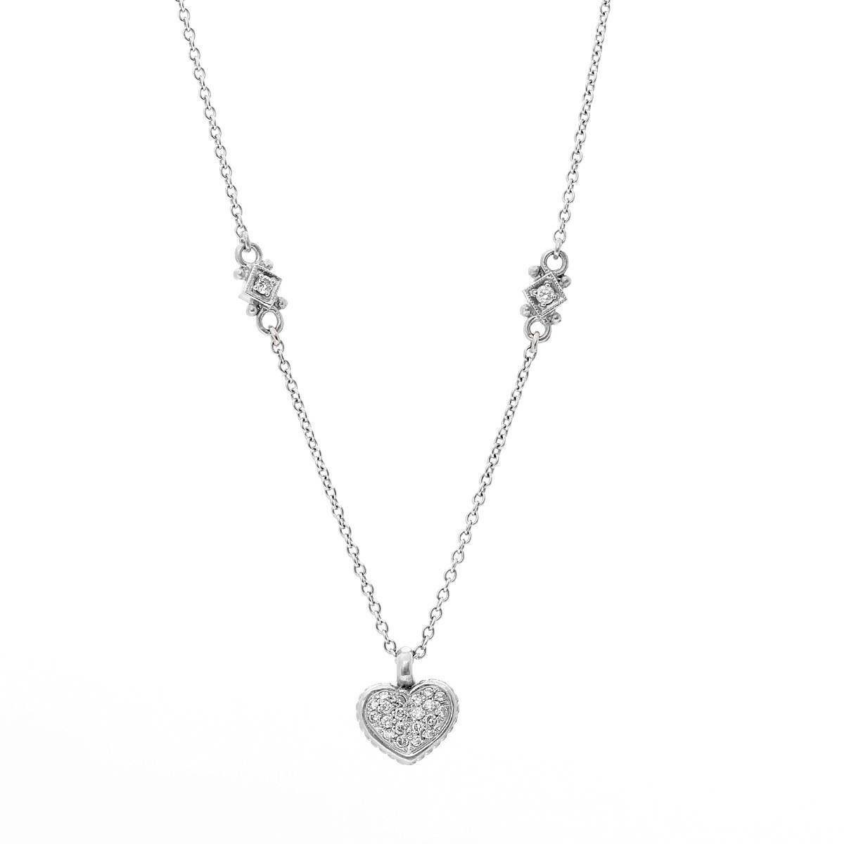 This beautiful Judith Ripka necklace features a pave diamond heart pendant with two diamond stations set in 18K white gold; one on each side. It is apx. 14-1/2 inches in length and weighs 8.3 grams. This necklace is comfortable and great for an