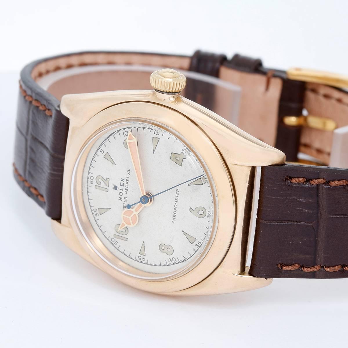 Vintage Rolex Yellow Gold Oyster Perpetual Bubbleback White Roman Arabic Dial  3131 -  Automatic winding. 14k yellow gold case with smooth bezel (31mm diameter). White Arabic numeral dial. Brown Croc strap band. Pre-owned with custom box; Vintage