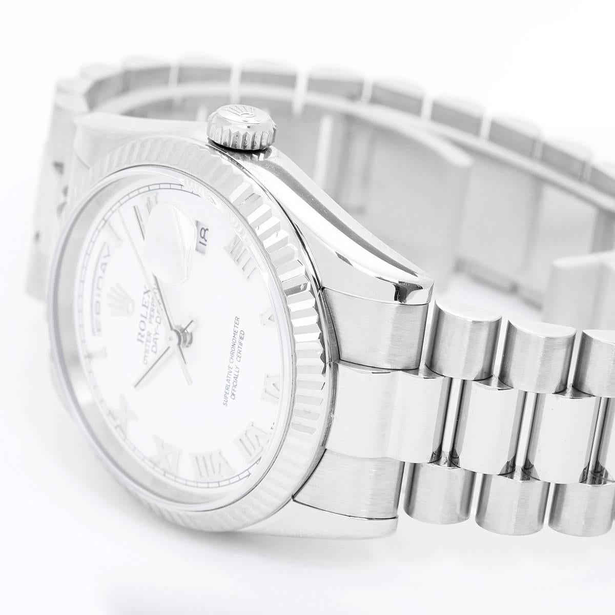Rolex President Day-Date Men's 18k White Gold Watch 118239 -  Automatic winding, 31 jewels, Quickset, sapphire crystal. 18k white gold case with fluted bezel (36mm diameter). White dial with Roman numerals. 18k white gold hidden-clasp President