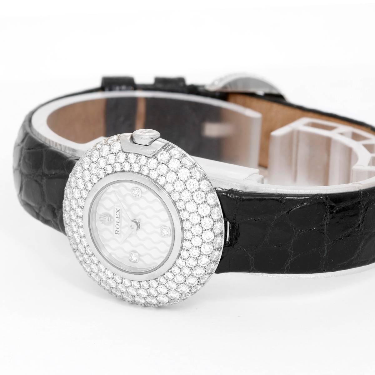 Rolex Cellini Orchid 18k White Gold Ladies Watch with 230 Diamonds  6201/9 BRIL -  Quartz. 18k white gold case, bezel set with 141 diamonds (26mm diameter). Factory mother of pearl diamond dial with 3 diamond hour markers. Black leather strap band;