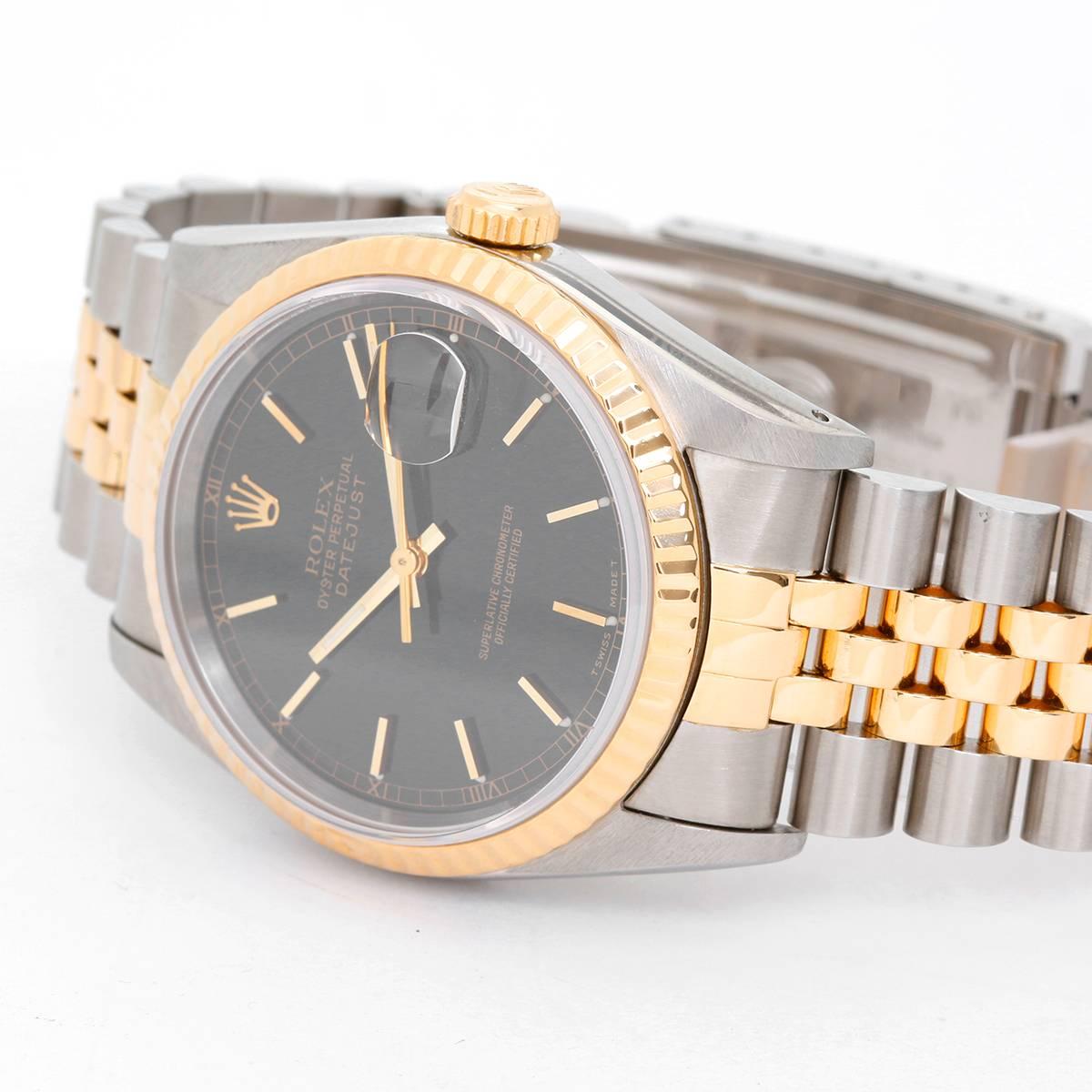 Rolex Datejust Men's 2-Tone Watch 16233 -  Automatic winding, 31 jewels, Quickset, sapphire crystal.  Stainless steel case with18k yellow gold  fluted bezel  (36mm diameter). Black dial with stick markers. Stainless steel and 18k yellow gold Jubilee