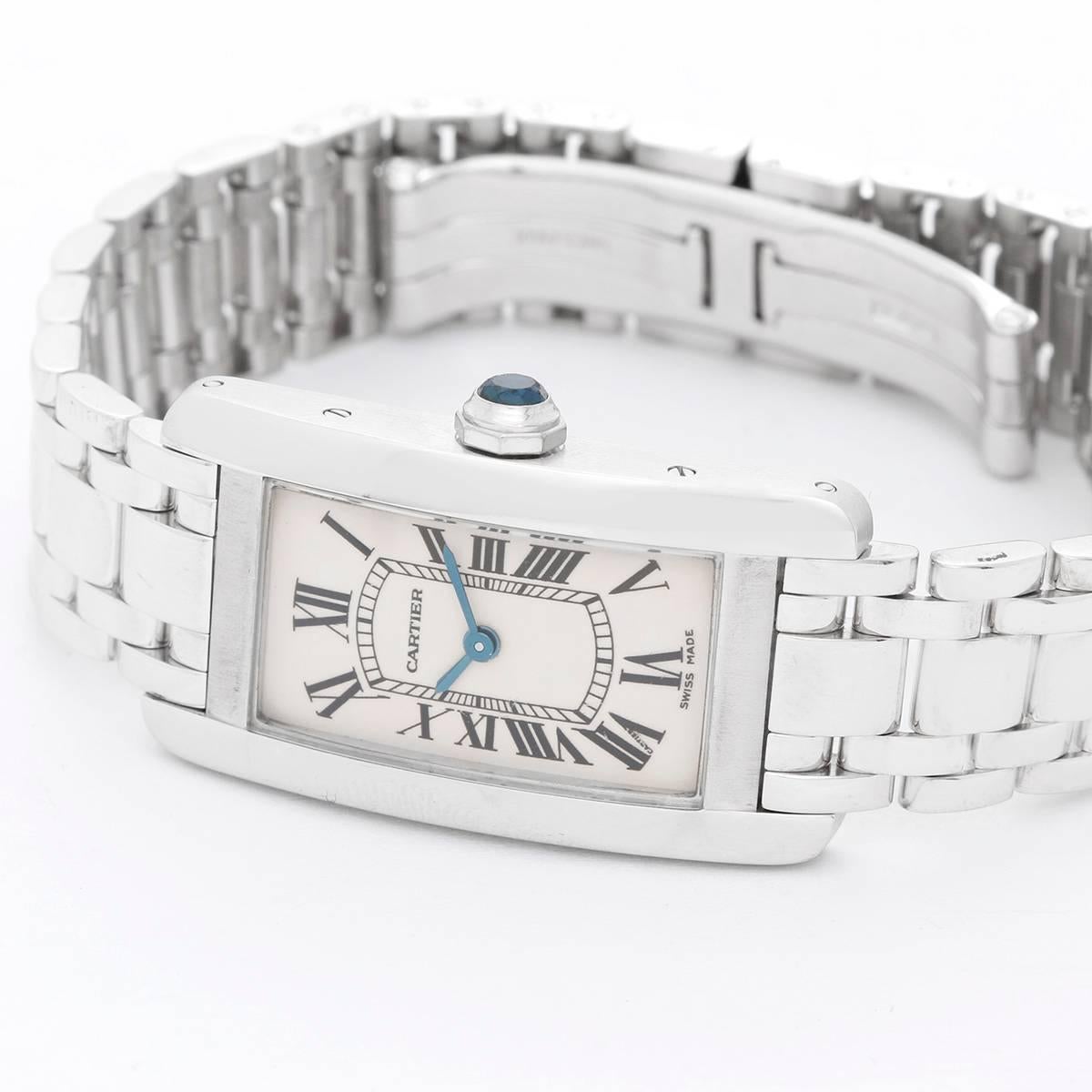 Cartier Tank Americaine Ladies White Gold W26019L1 -  Quartz movement. 18k white gold case (19mm x 40mm). Ivory colored with black Roman numerals. 18k white gold Cartier bracelet with deployant clasp. (Will fit apx. 6-1/2-in. wrist). Pre-owned with